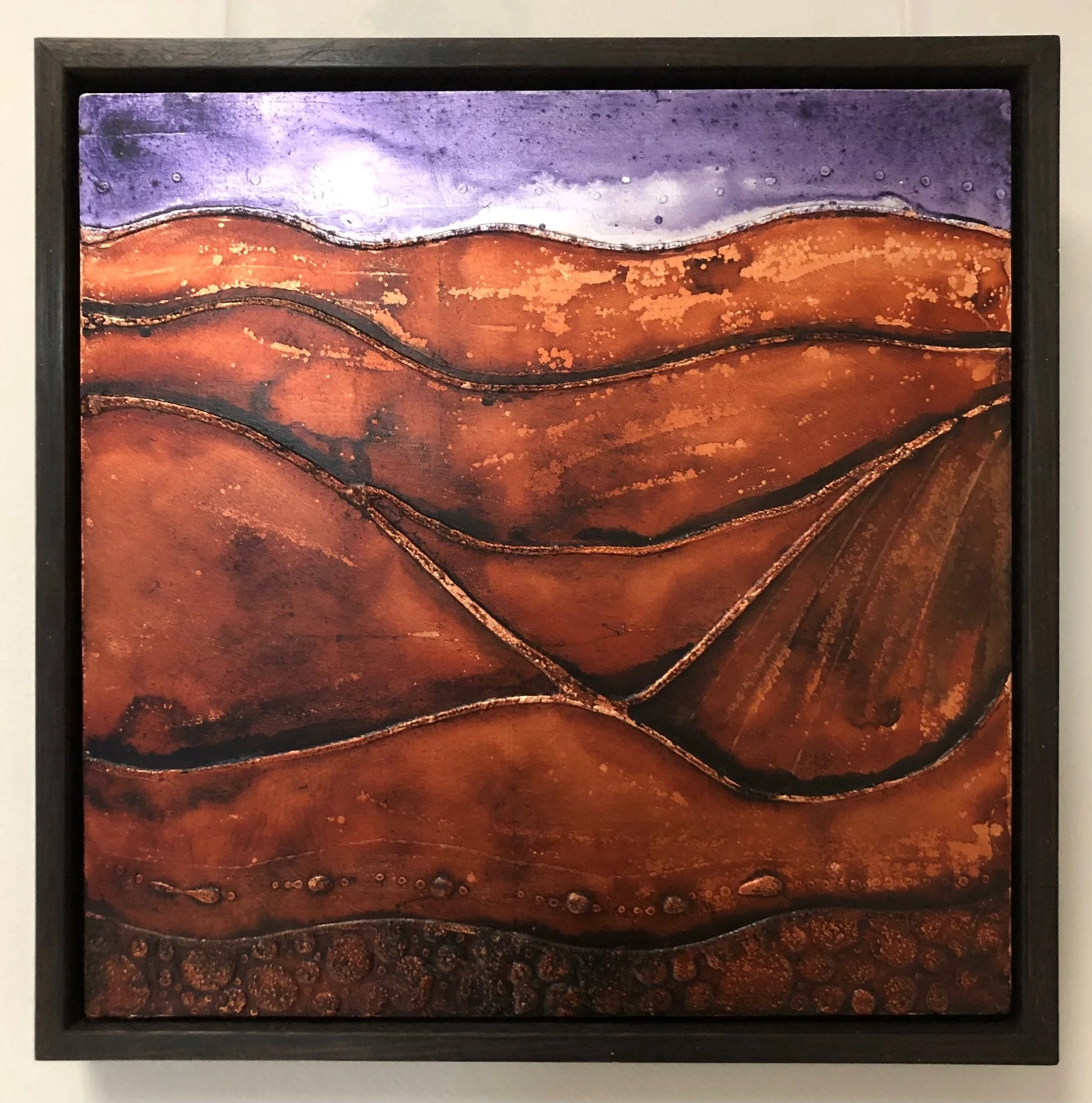 Abstract painting of layered, wavy, earthy-toned hills in shades of brown, orange, and purple with textured patterns.