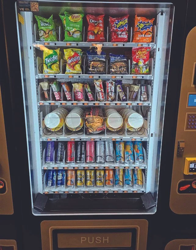 A VMT vending machine stocked with food and drinks