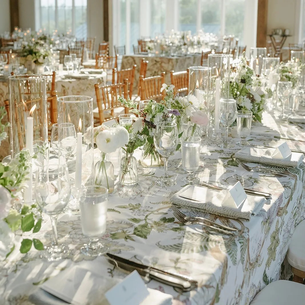 Refined and fresh.  A tablescape designed to feel luminous and layered.

These botanical patterned linens set a romantic foundation, softened by a delicate florals in whites and subtle blush while adding organic movement down the length of the table.