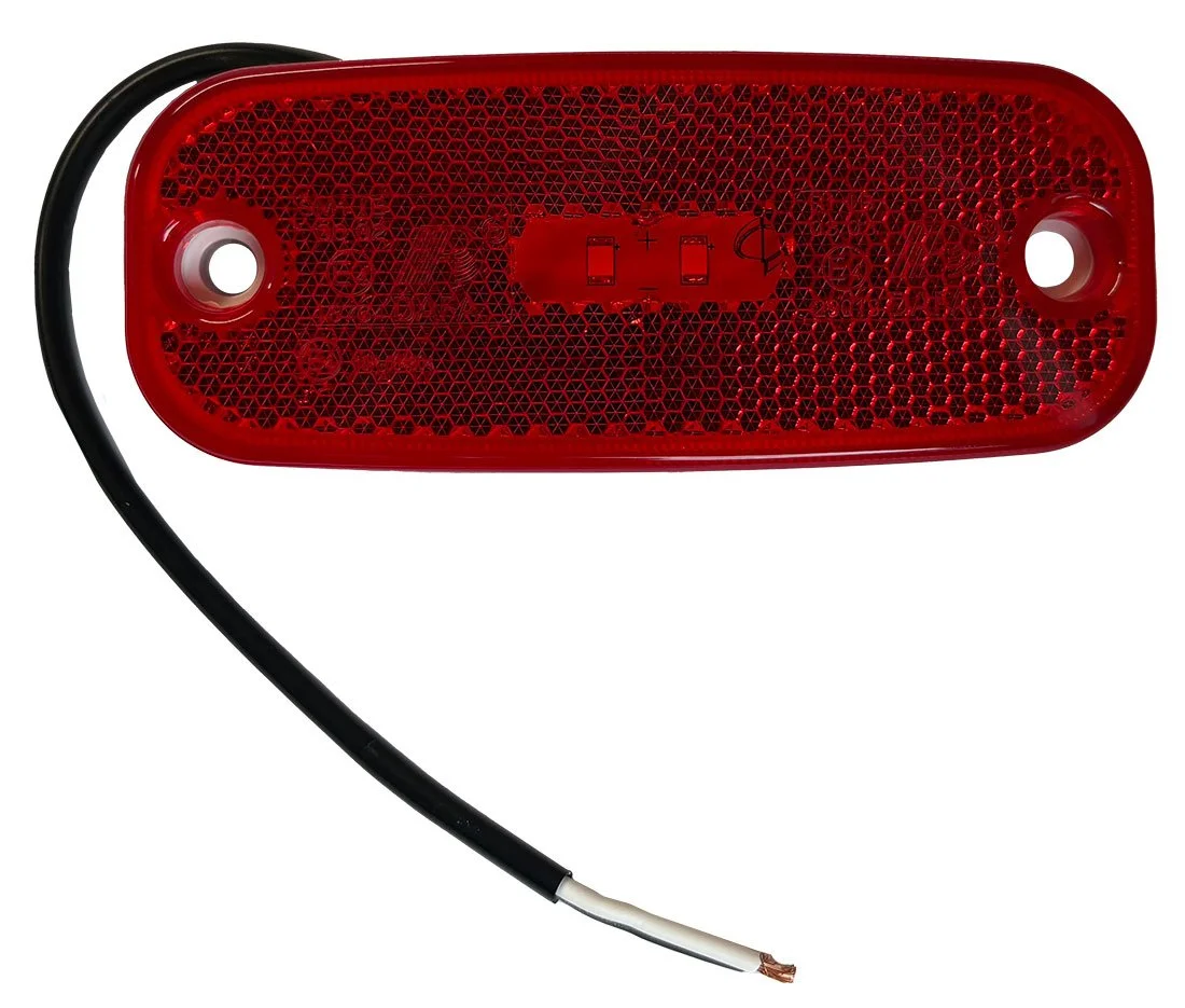 Red trailer tail light with black cable, viewed from behind, with a reflective honeycomb pattern and mounting holes.