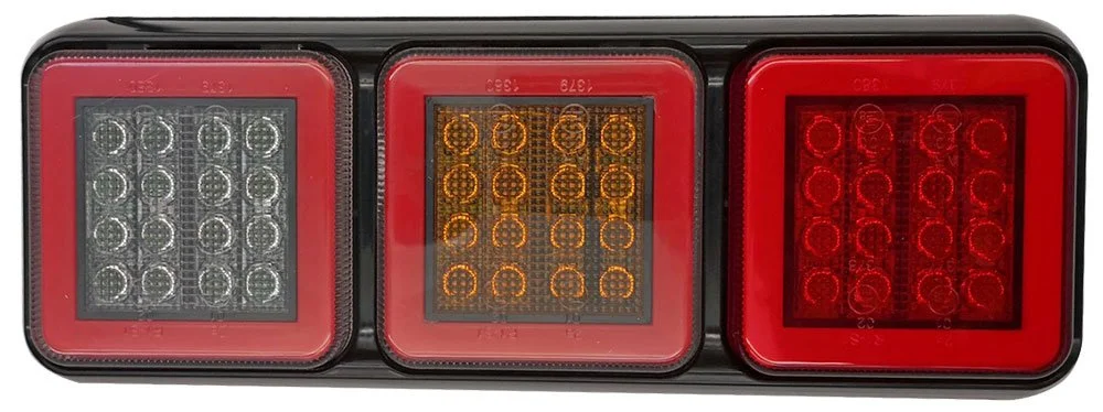 Trailer rear tail light with three sections: the left section with clear lights, the middle with orange lights, and the right with red lights.