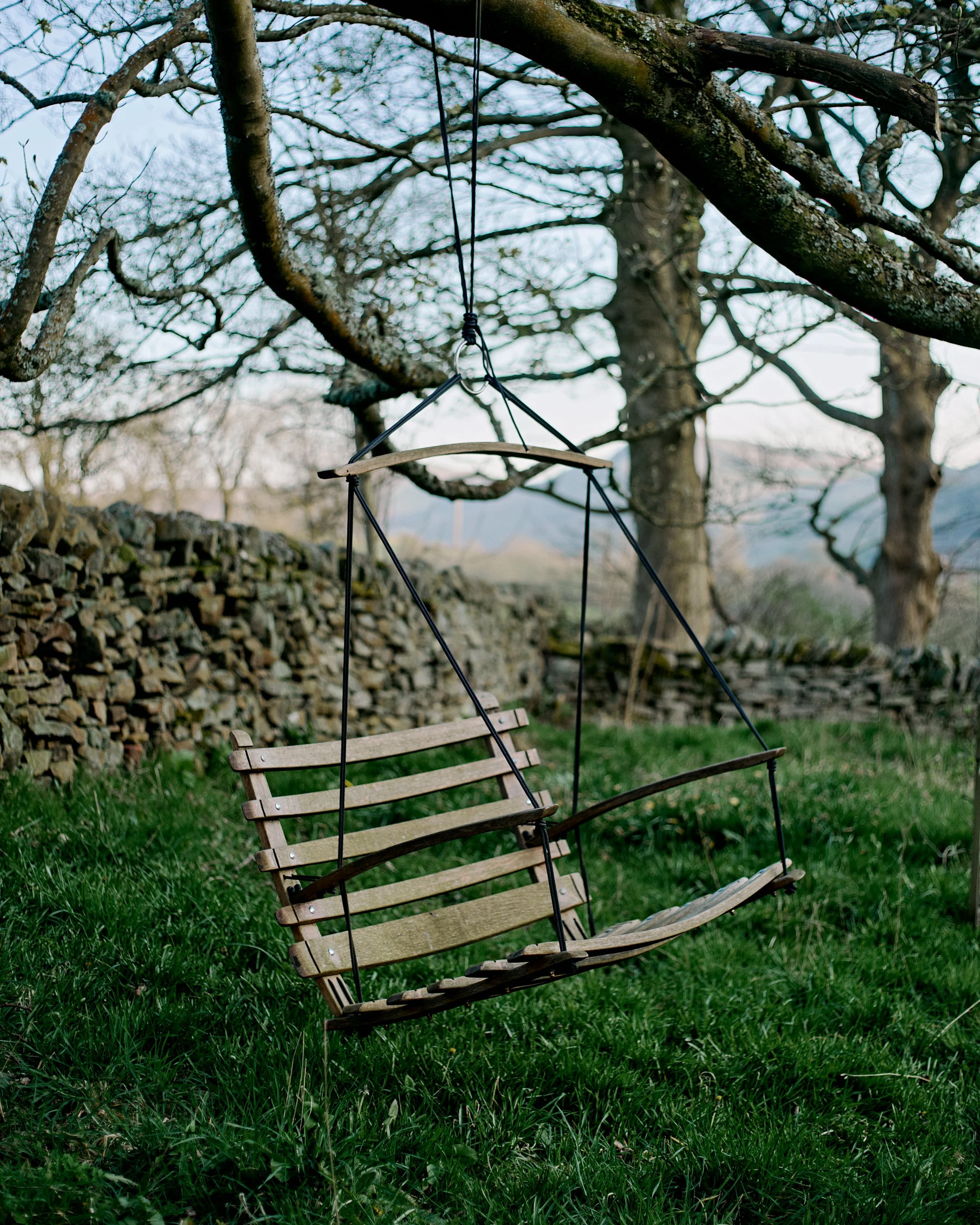 Swinging chair in garden with hills behing