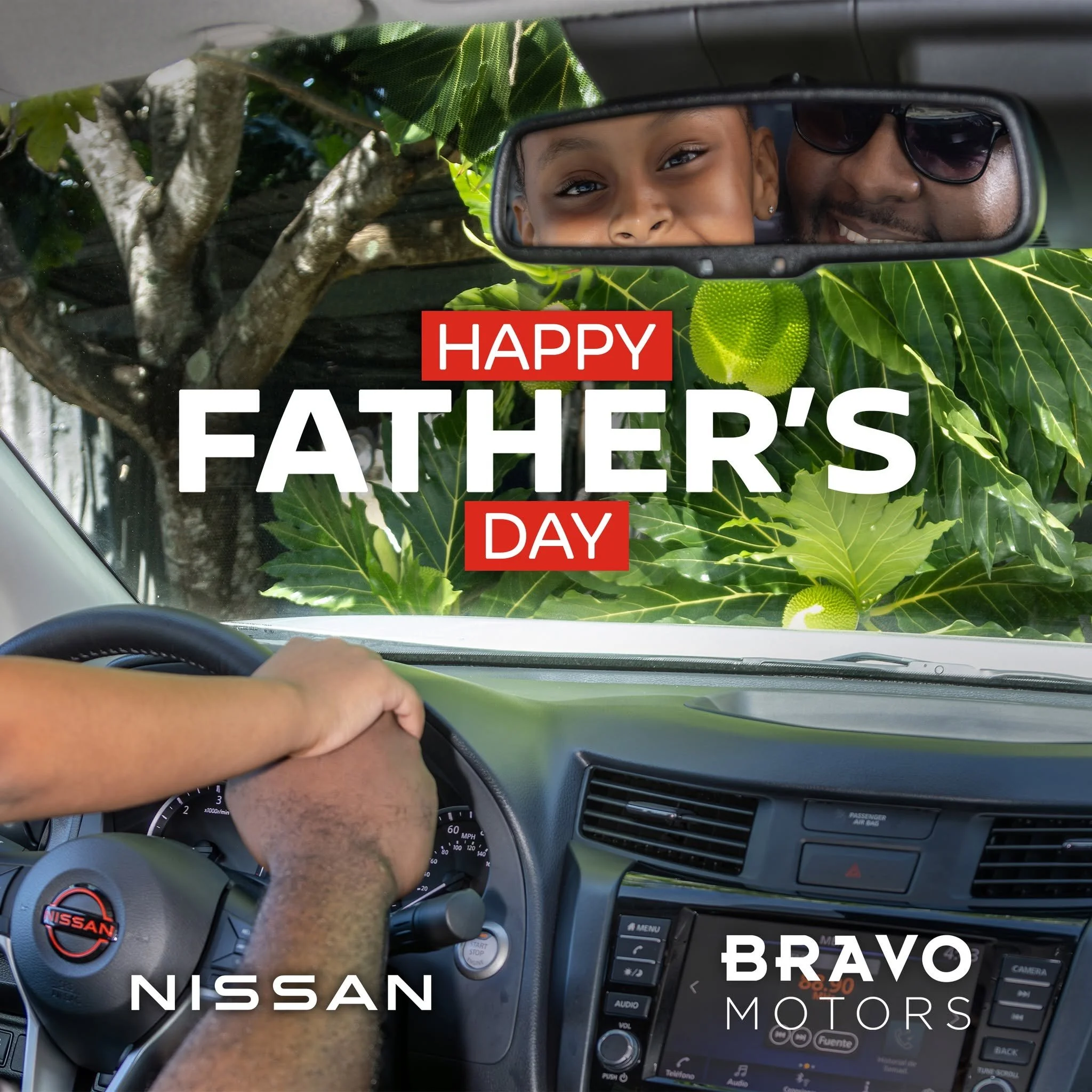Father and child reflected in a vehicle mirror