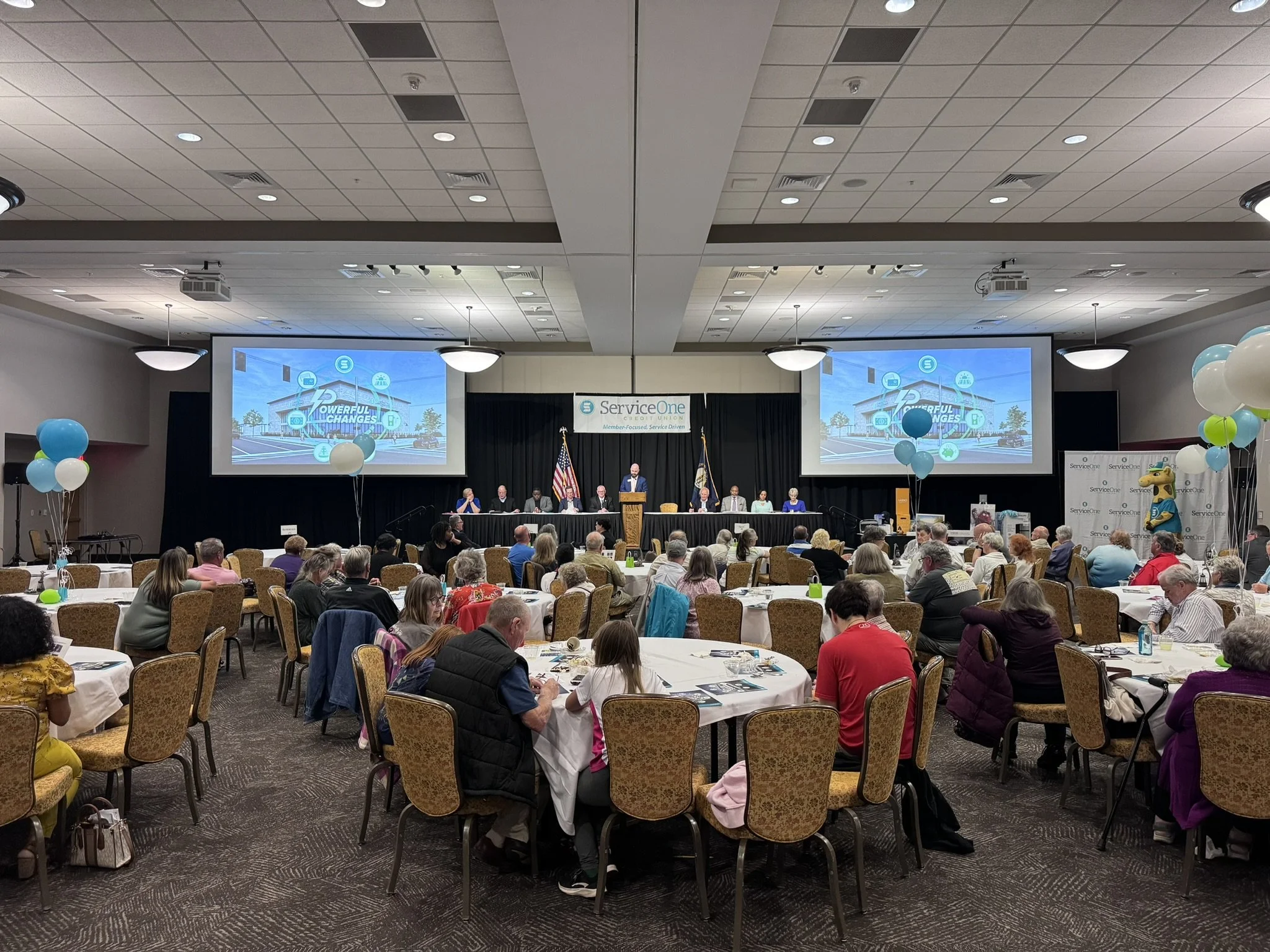 2024 SOCU Annual Shareholders' Meeting - room full of people, speaker at podium