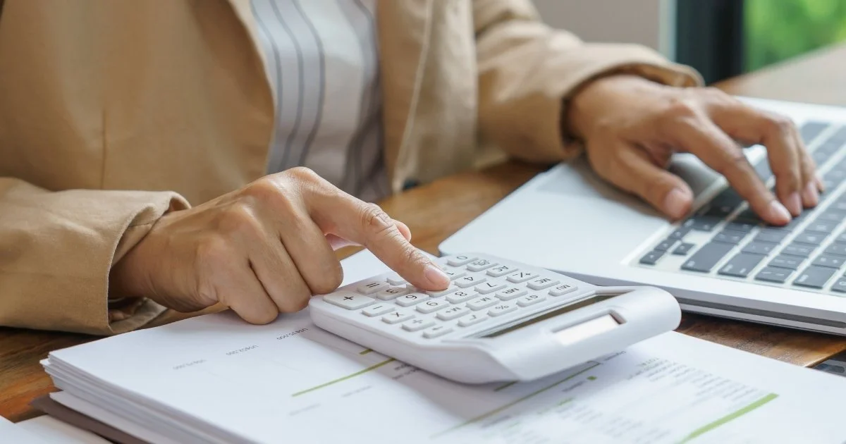 Finance review with calculator and laptop