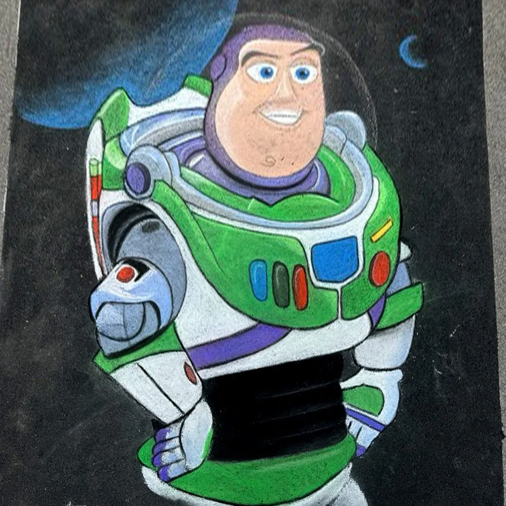 Mother and Daughter artists with their 6 foot by 8 foot chalk drawing of Buzz Lightyear 