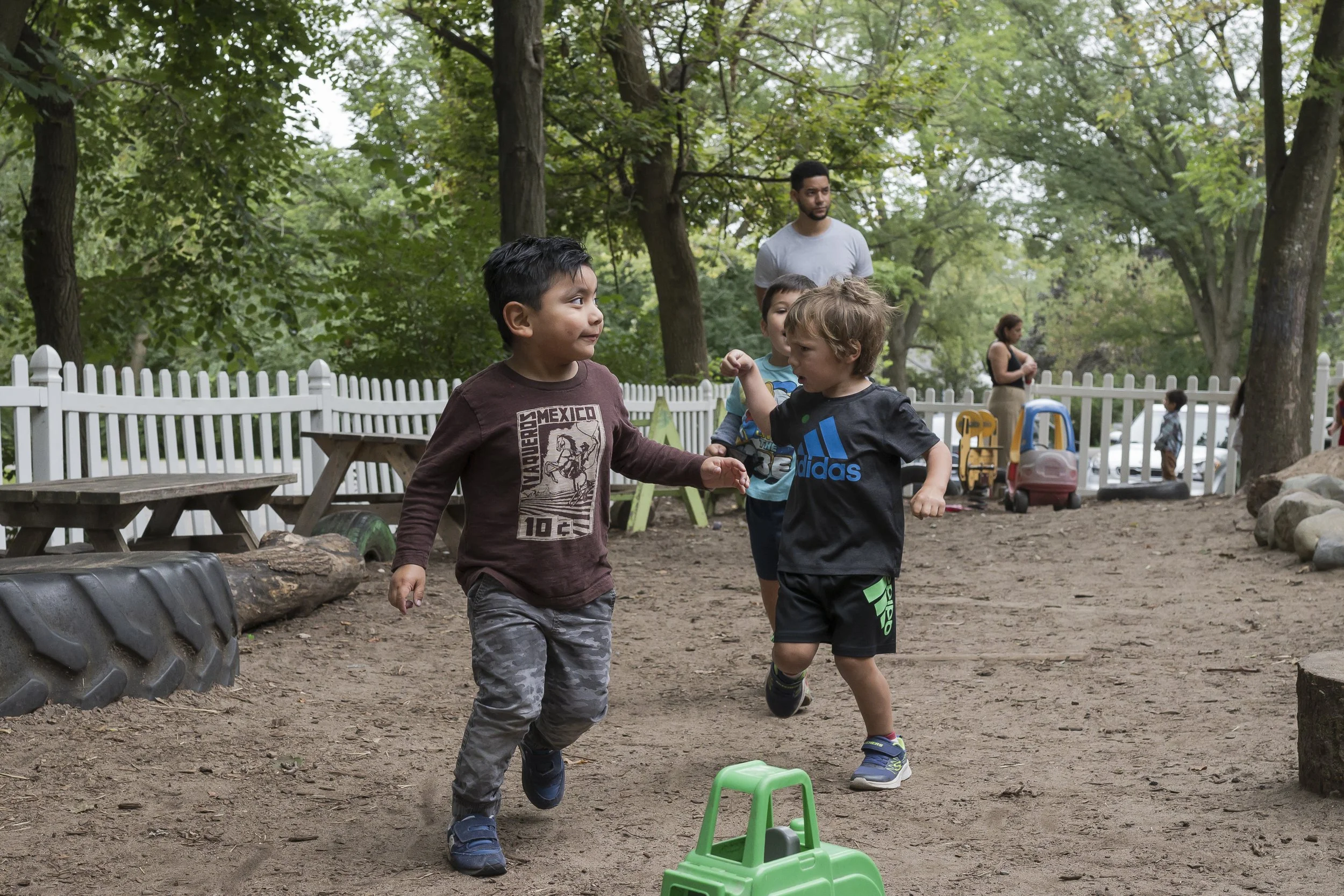 Preschool children enjoying active outdoor play in a natural playground