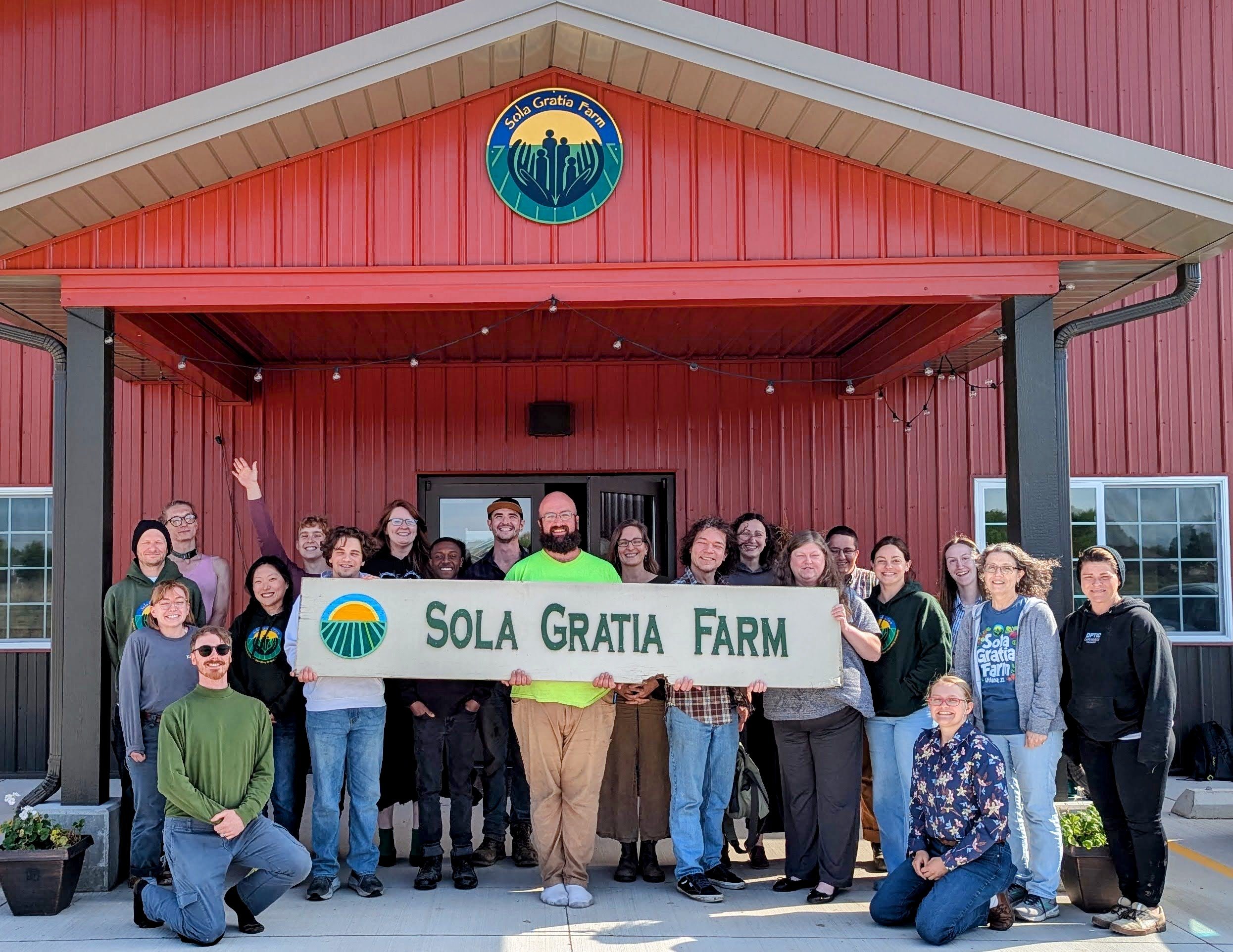 Sola Gratia staff in front of building
