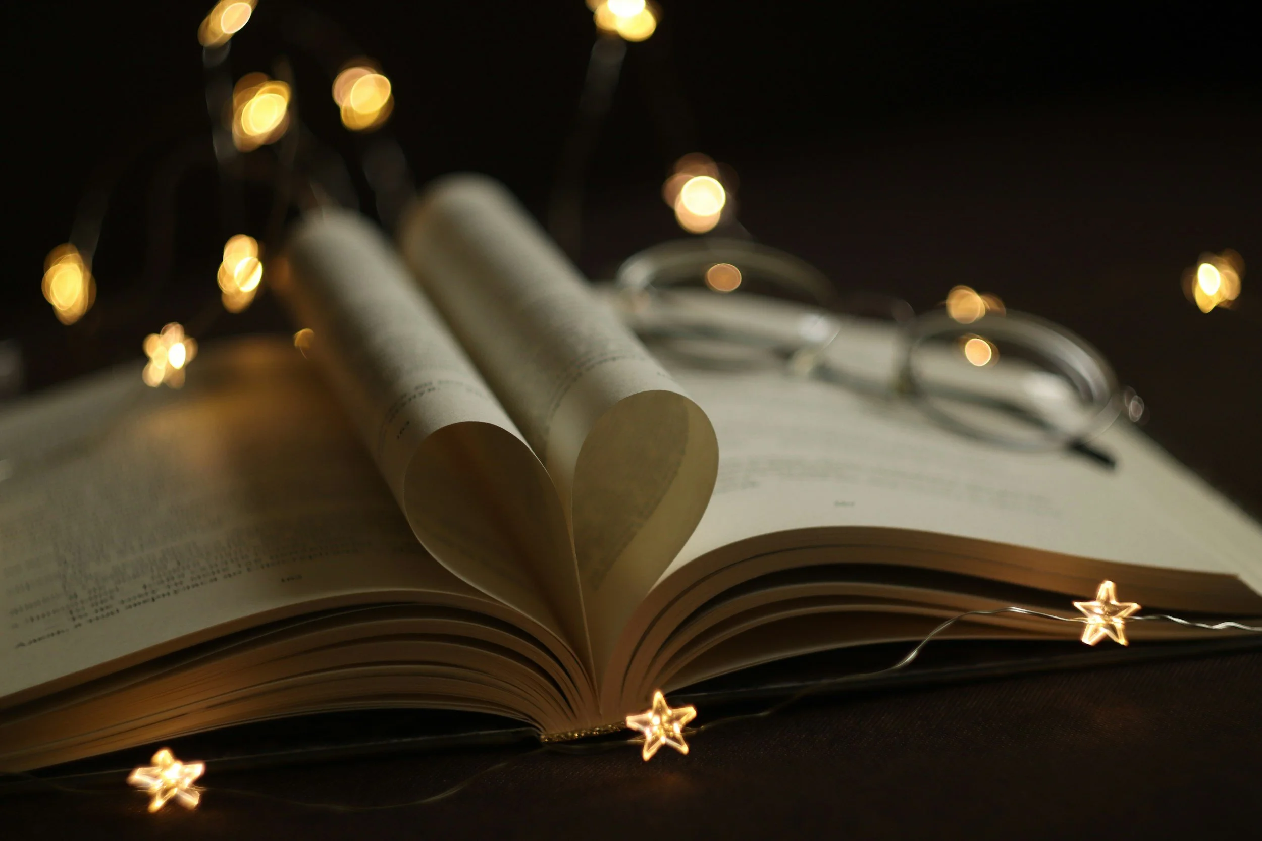 open book with fairy lights in shape of stars