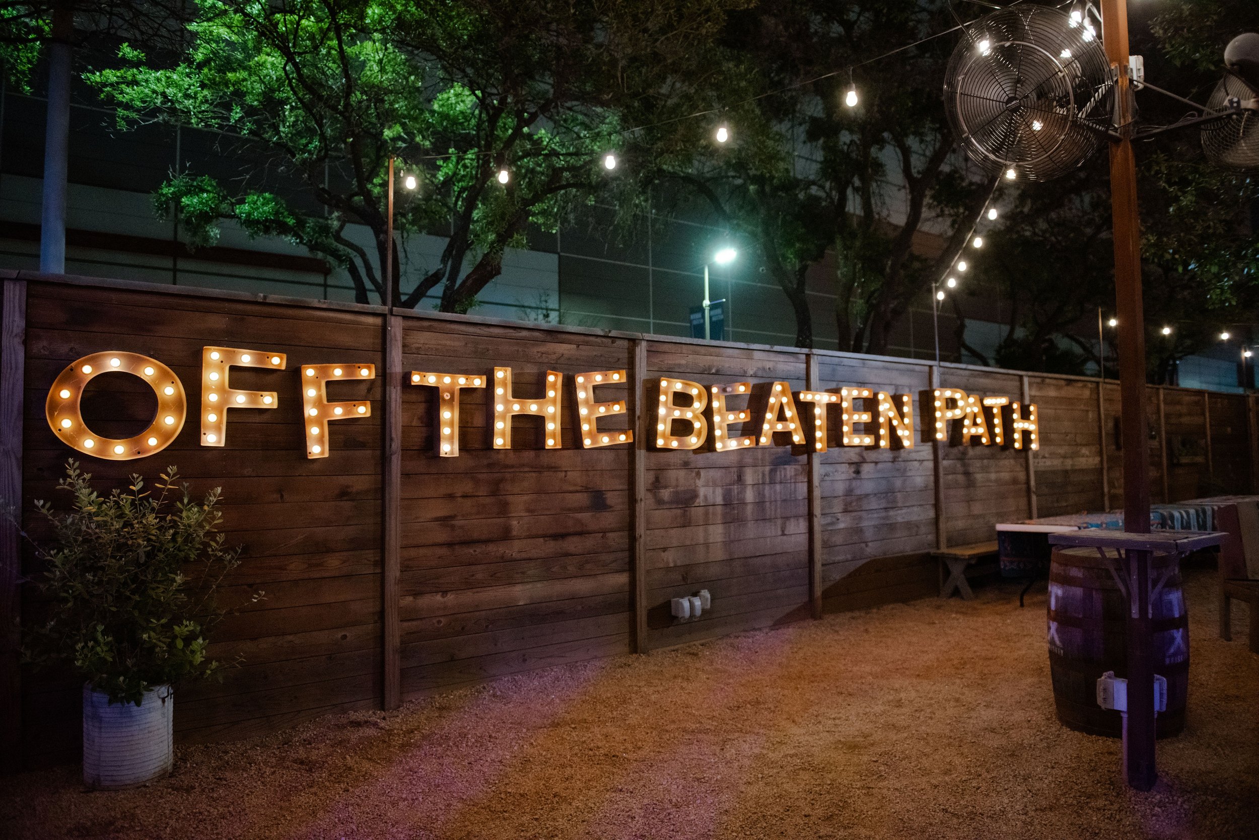 A charming outdoor venue at a restaurant adorned with lit marquee letters, creating a warm and inviting ambiance, captured in a captivating photo by a skilled Houston event photographer.