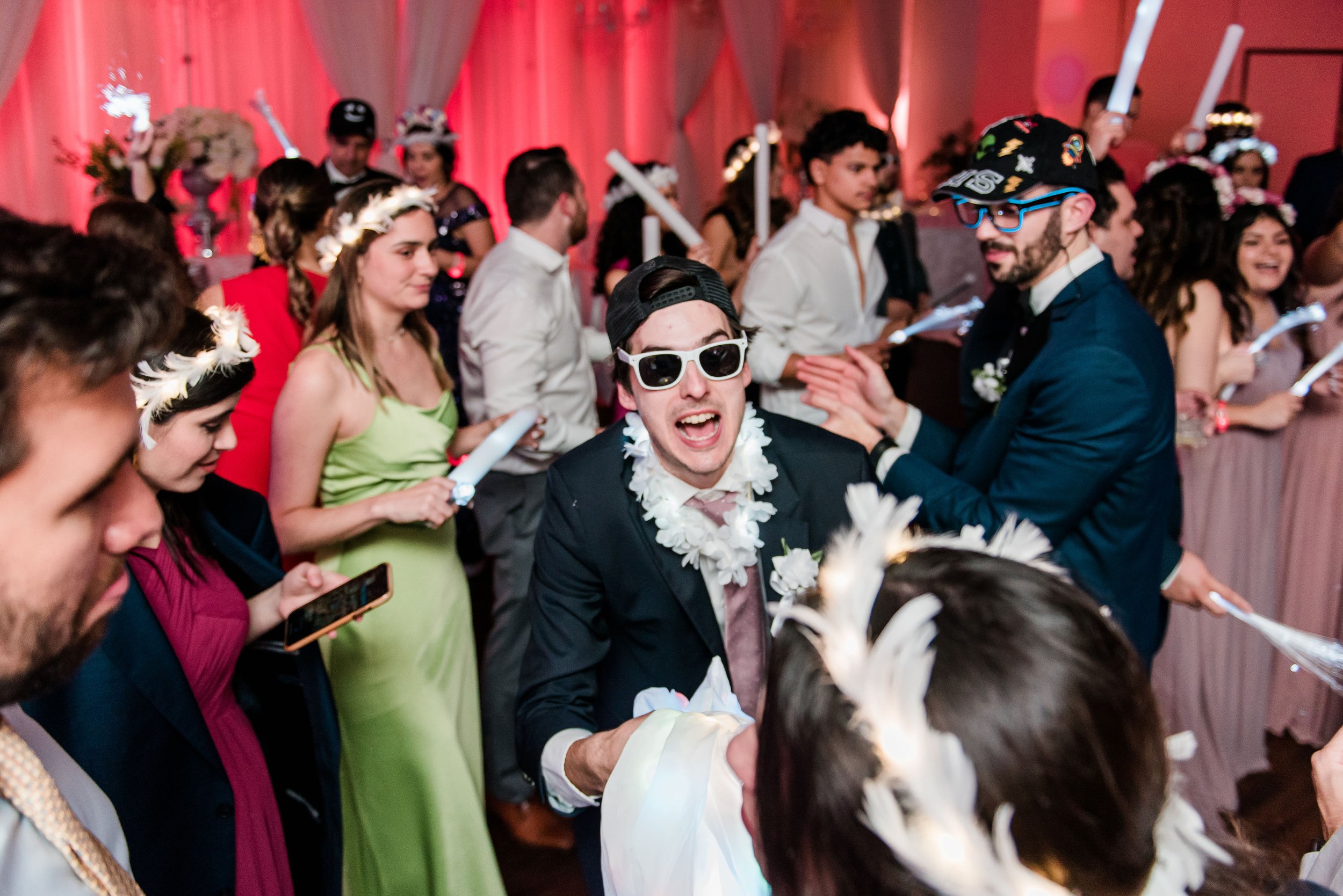 Couples and friends gathered together, laughing and conversing, enveloped in the atmosphere of joy and celebration at events, captured with authenticity by an experienced event photographer in Houston.
