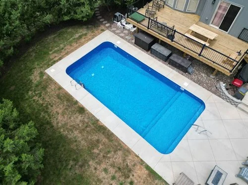 A clean and classic 16x32 rectangular vinyl liner inground pool with full-length sun deck, installed by Tiger Pool and Patio.