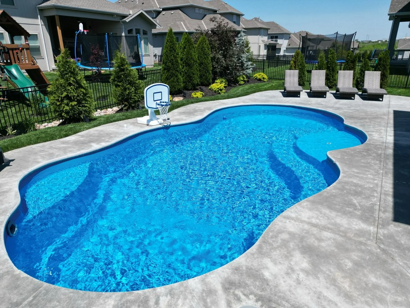 This Thursday Pools Sun Day 15x30 freeform project is a great example of intentional landscaping. The concrete and pool shapes flow right with the landscaping instead of forcing straight lines where they don&rsquo;t belong. Pair that with the clean f