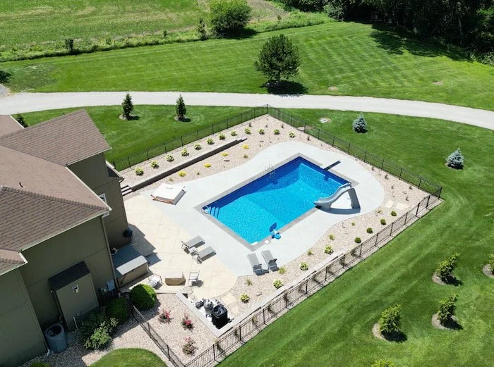 Kansas City inground pool installation featuring 18x40 Diver vinyl liner pool with a GLI Cayman Mystic Light Blue liner, 8-foot deep end with diving board, and complete backyard pool and patio landscaping.