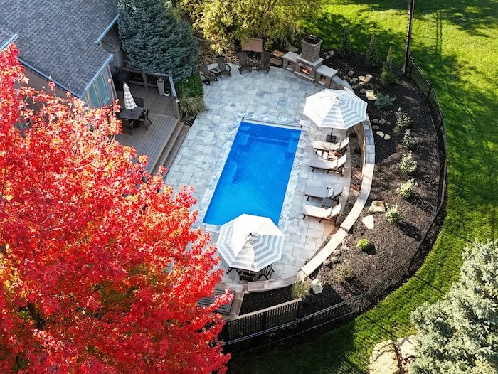 Fall aerial view of a Tiger Pool and Patio fiberglass inground pool installation in Kansas City.