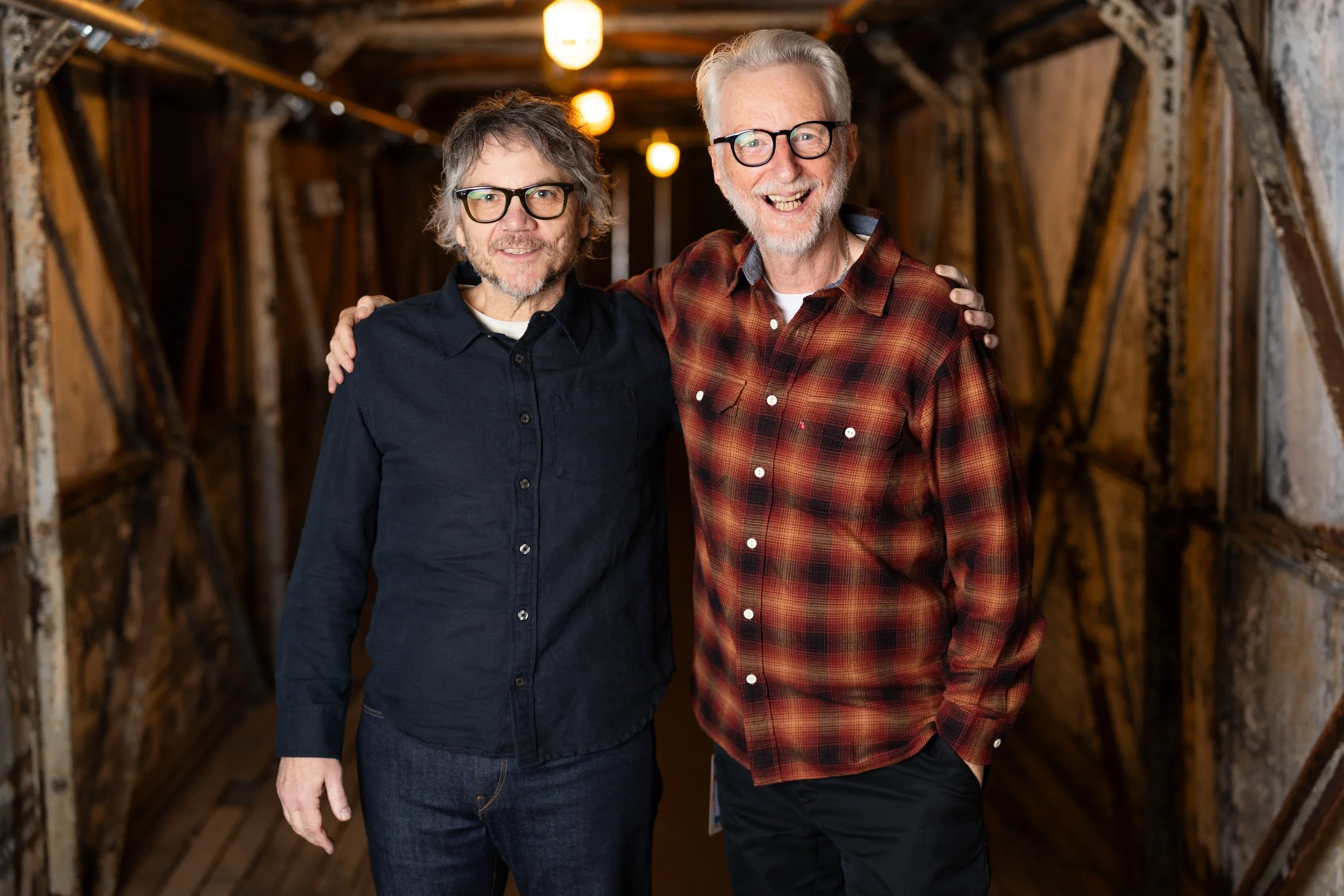 Wilco's Jeff Tweedy and Billy Bragg standing before walking on stage at the 2026 Solid Sound Festival to perform their joint album, Mermaid Avenue, live for the first time in history.
