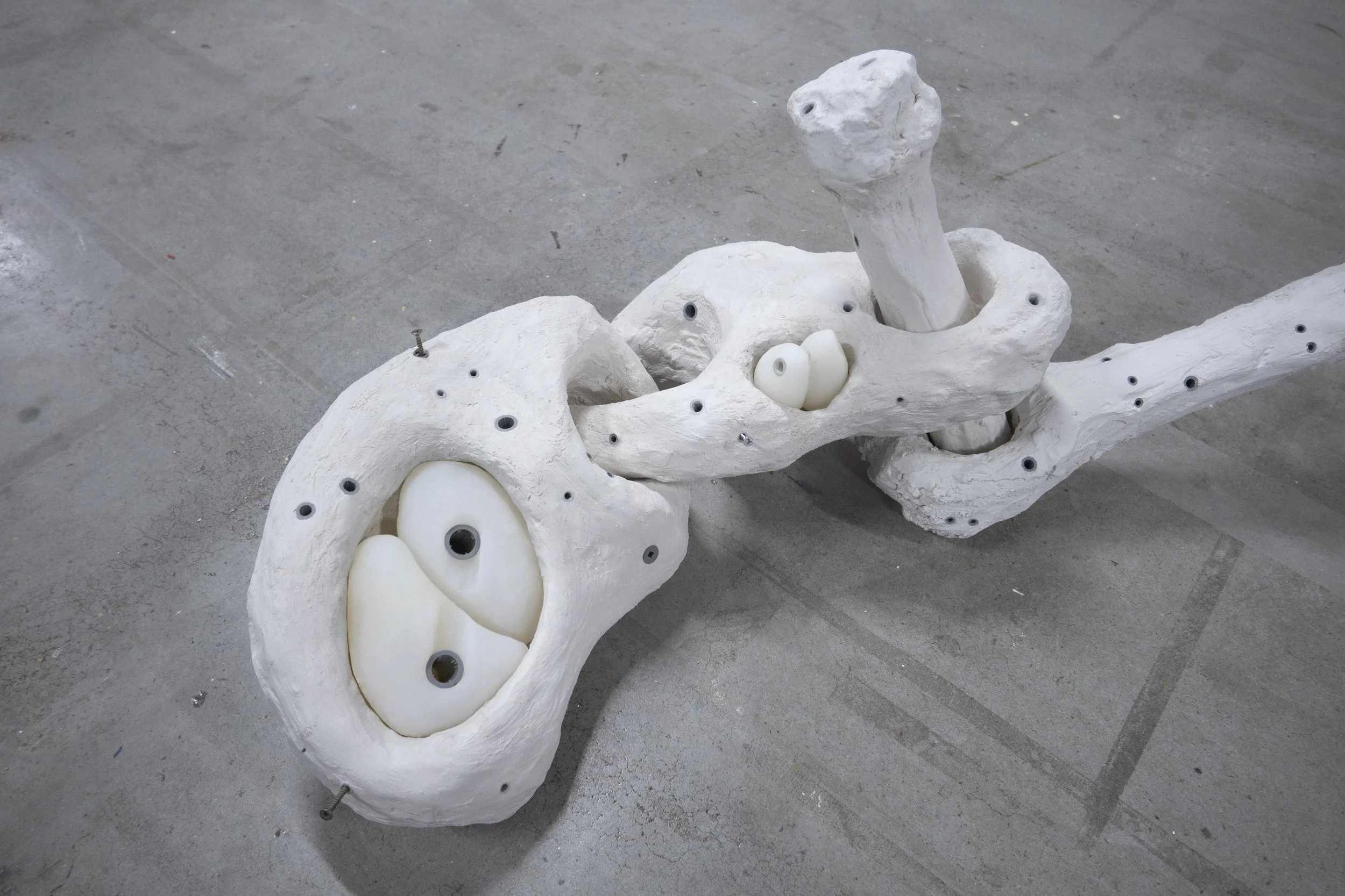 Close-up of the twisted joint-like section of “Wrist,” highlighting the plaster textures and silicone tension within the structure.