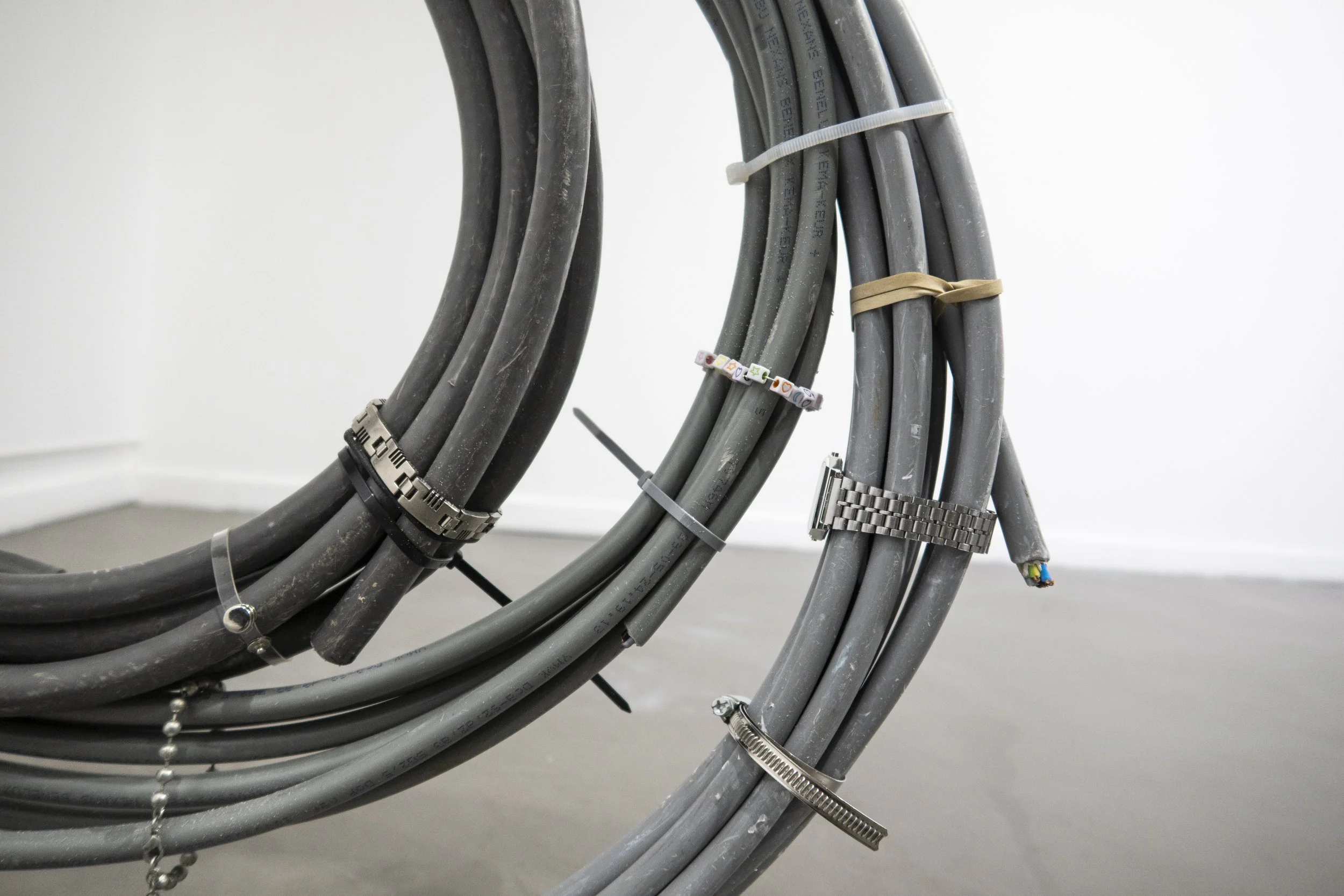 Close-up of the intertwined power cables and metallic fittings in the sculpture “Sunrise,” exhibited at Platform Stockholm and Loods 6.