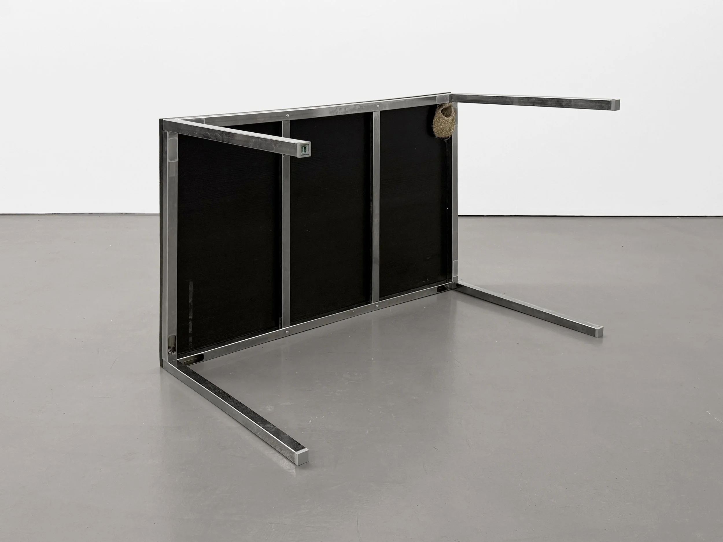 Installation view of “Three Views from a Nest,” a metal table sculpture with a bird nest attached, exhibited at Platform Stockholm.