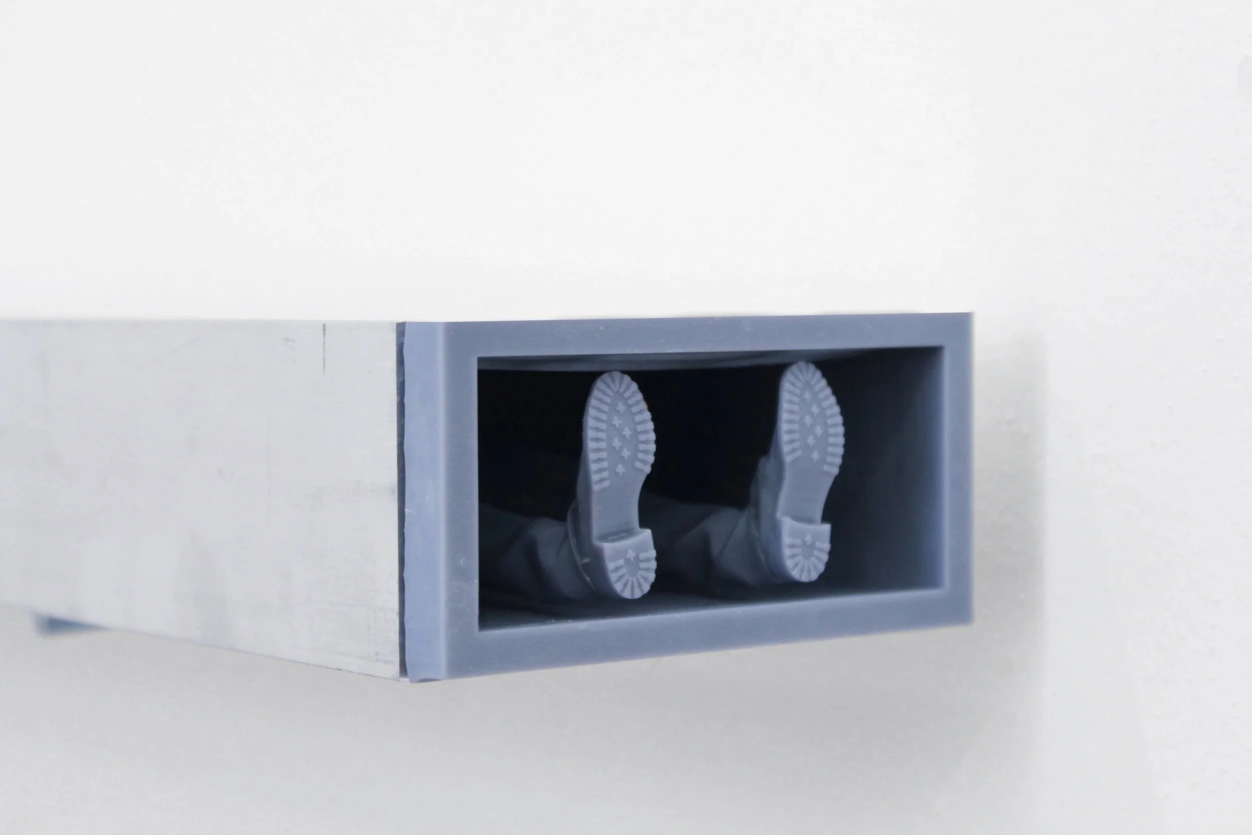 Detail of Brink showing the shoe sole and leg-like forms embedded in the sculptural composition.
