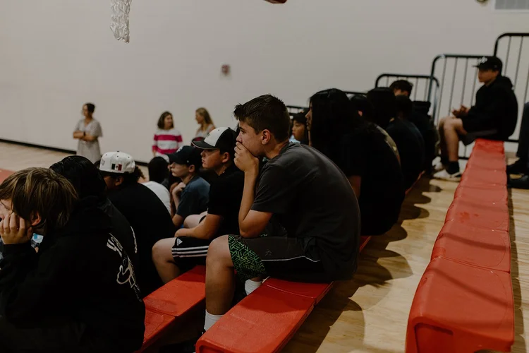 Students in the bleachers laughing during an OOTC school assembly