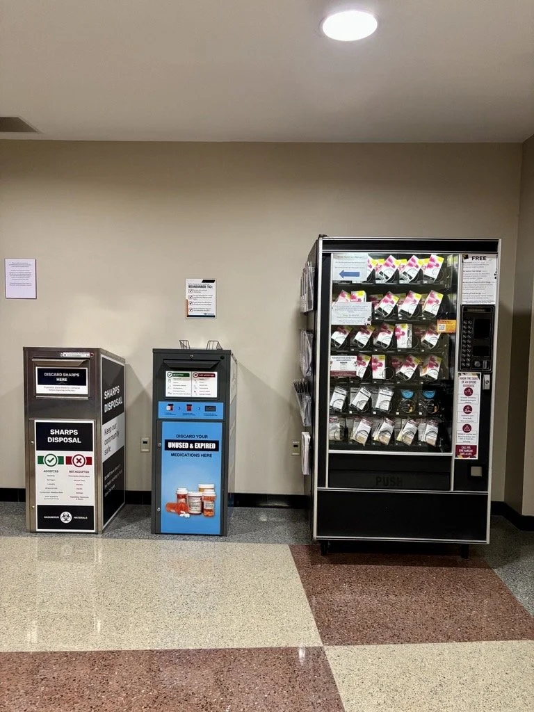 Vending machine with overdose prevention supplies next to a drop box for disposing sharps and one for disposing medicine.
