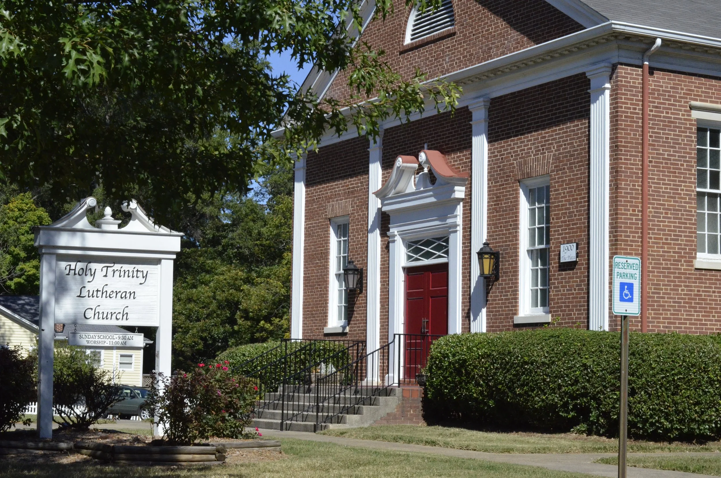 The front steps of the sanctuary, with the Holy Trinity Lutheran Church sign in front