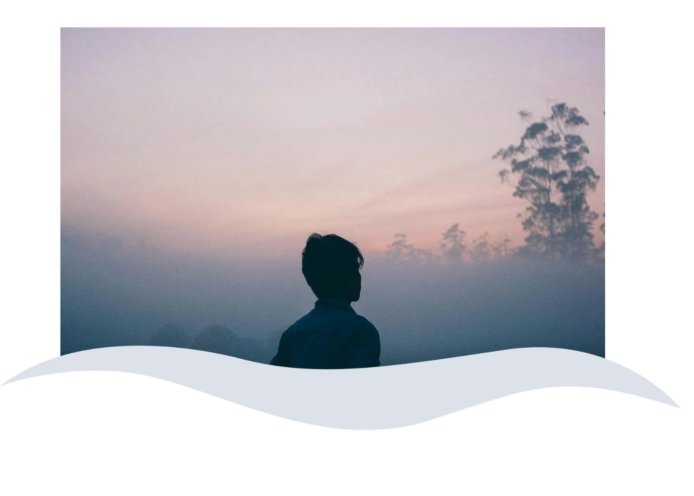 Silhouette of a person in front of a foggy landscape with trees and a pastel-colored sky.