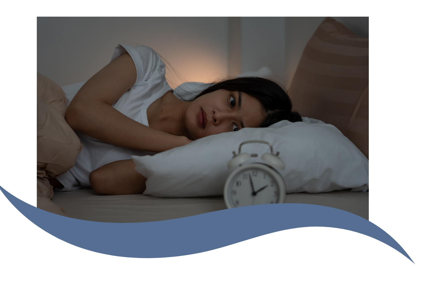 A woman lying on her side in bed with a worried expression, resting her head on a pillow, with an alarm clock showing 6:03 in the foreground.