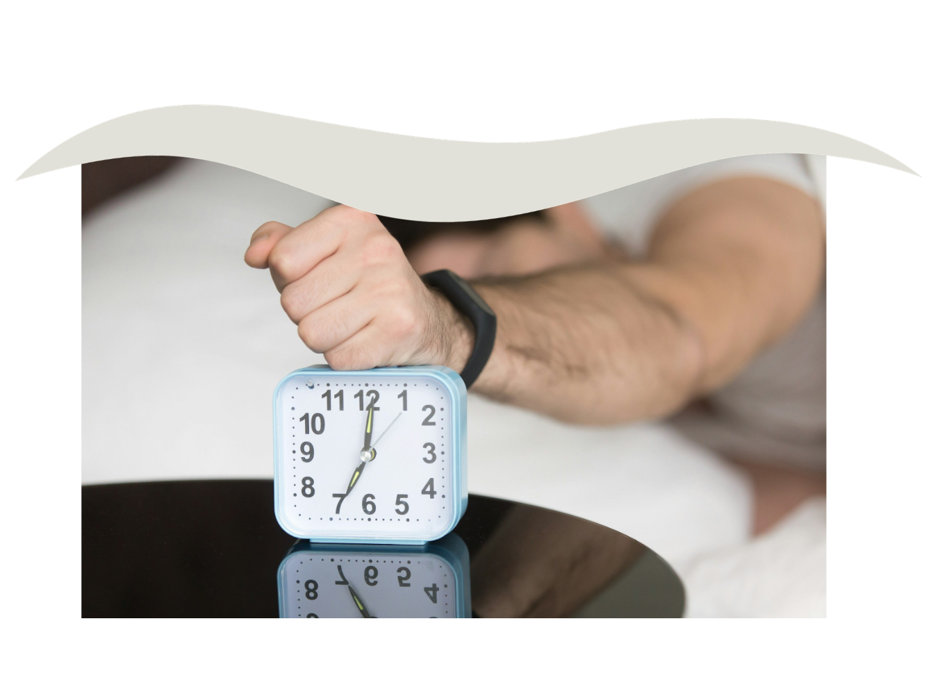 Person adjusting a small blue clock on a reflective black surface, with a blurred background.