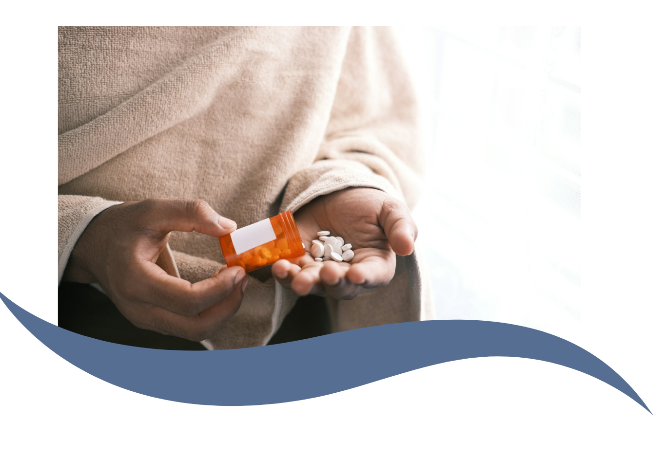 Person holding an orange prescription pill bottle and spilling white pills into their palm, near a window with light coming through.