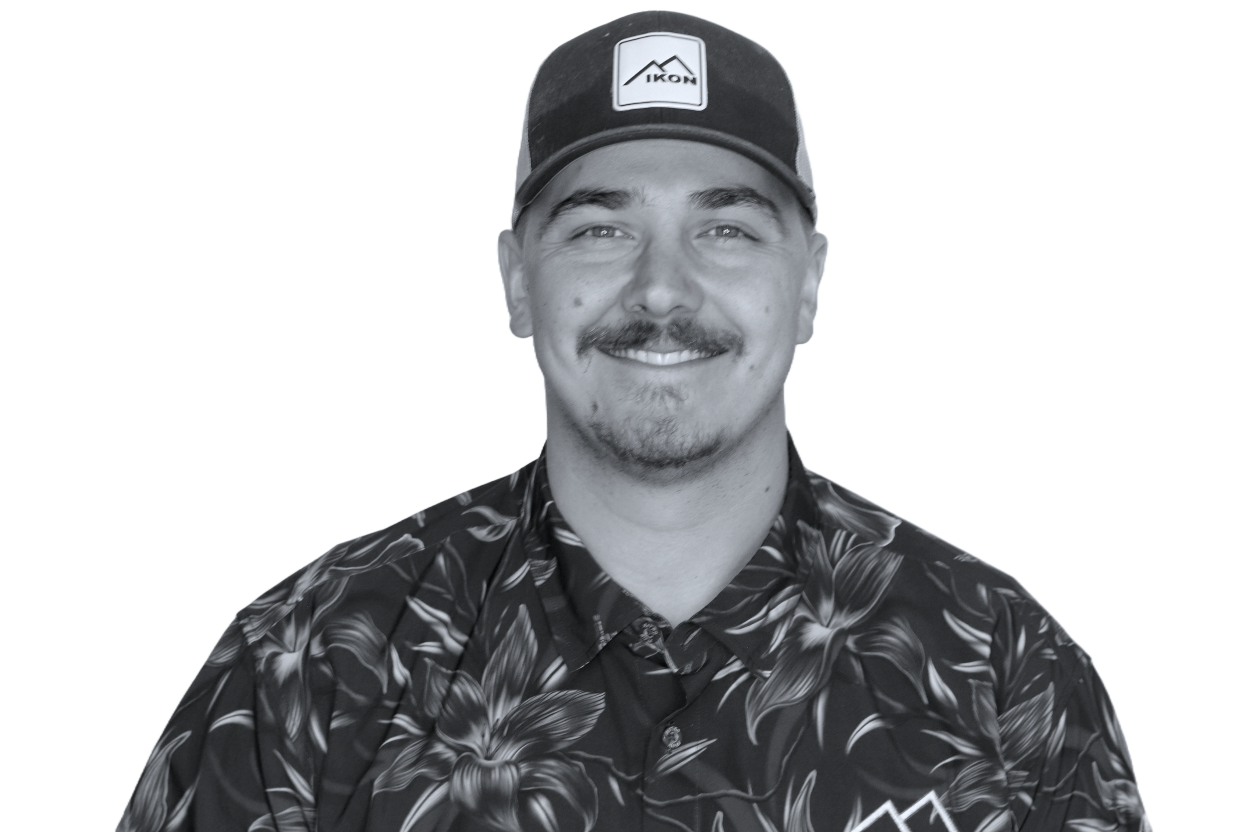 Black and white portrait of a smiling person wearing a camo jacket and white hoodie.