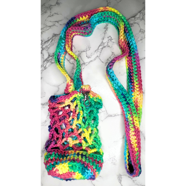 Colorful rainbow crochet water bottle holder with net-style stitching and a keychain clip, displayed flat on a marble surface
