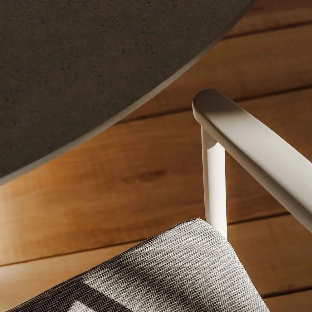 Close-up of a modern chair and table in warm natural light, representing a clean, professional consulting environment.