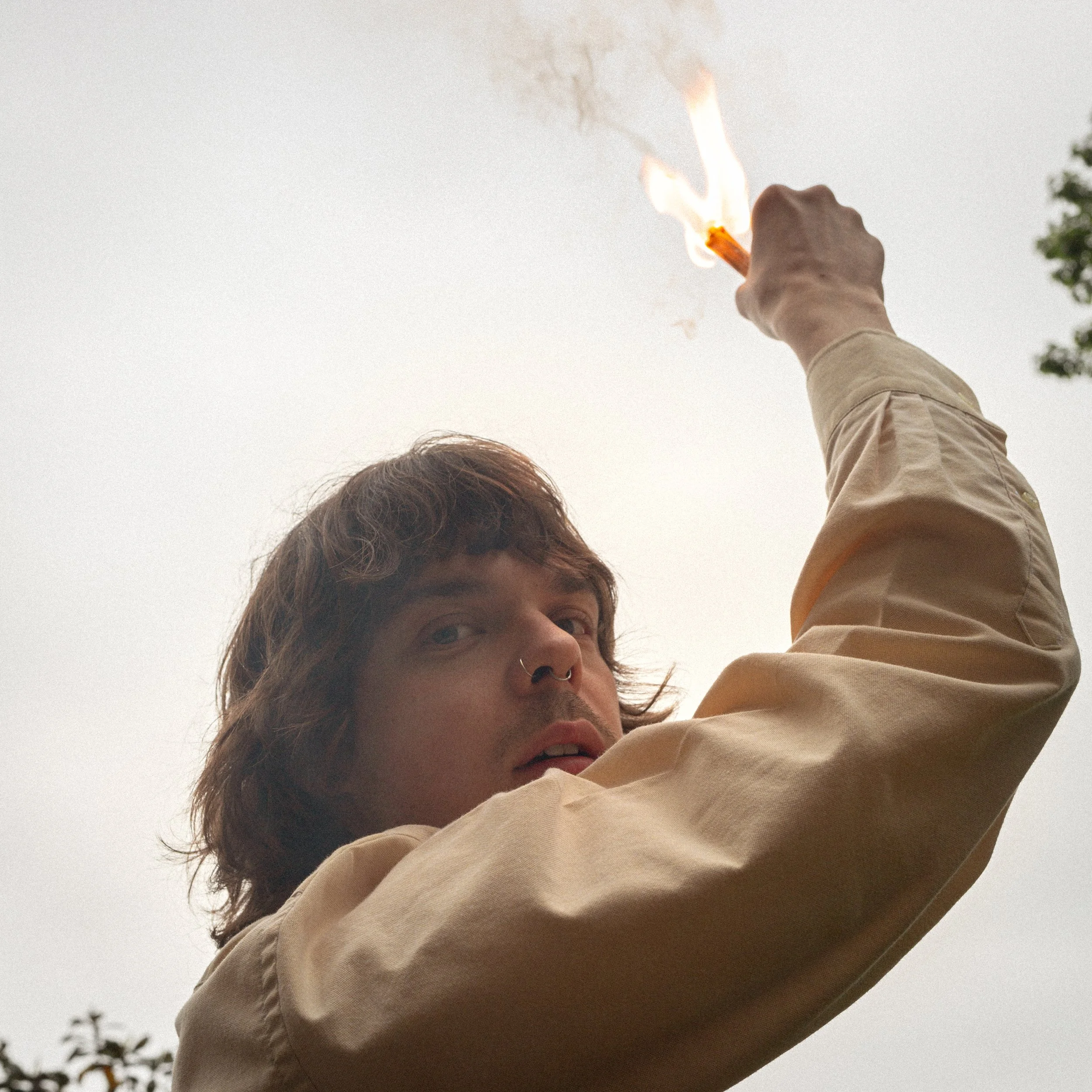 Morgan holding a lit match up to the sky