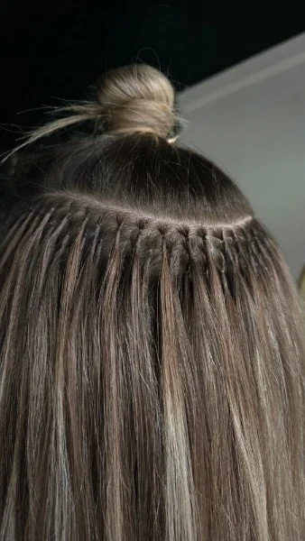 K-tip hot fusion extensions shown on a client in salon