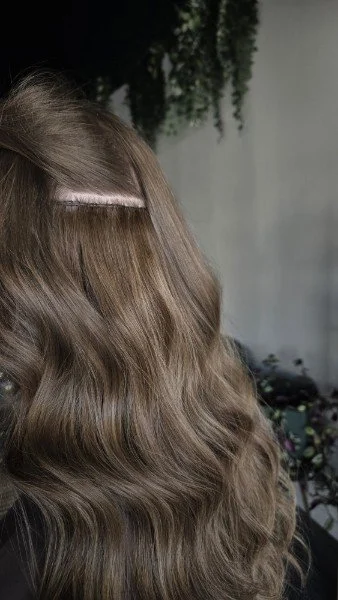 Invisible Bead Extensions shown on a client in salon