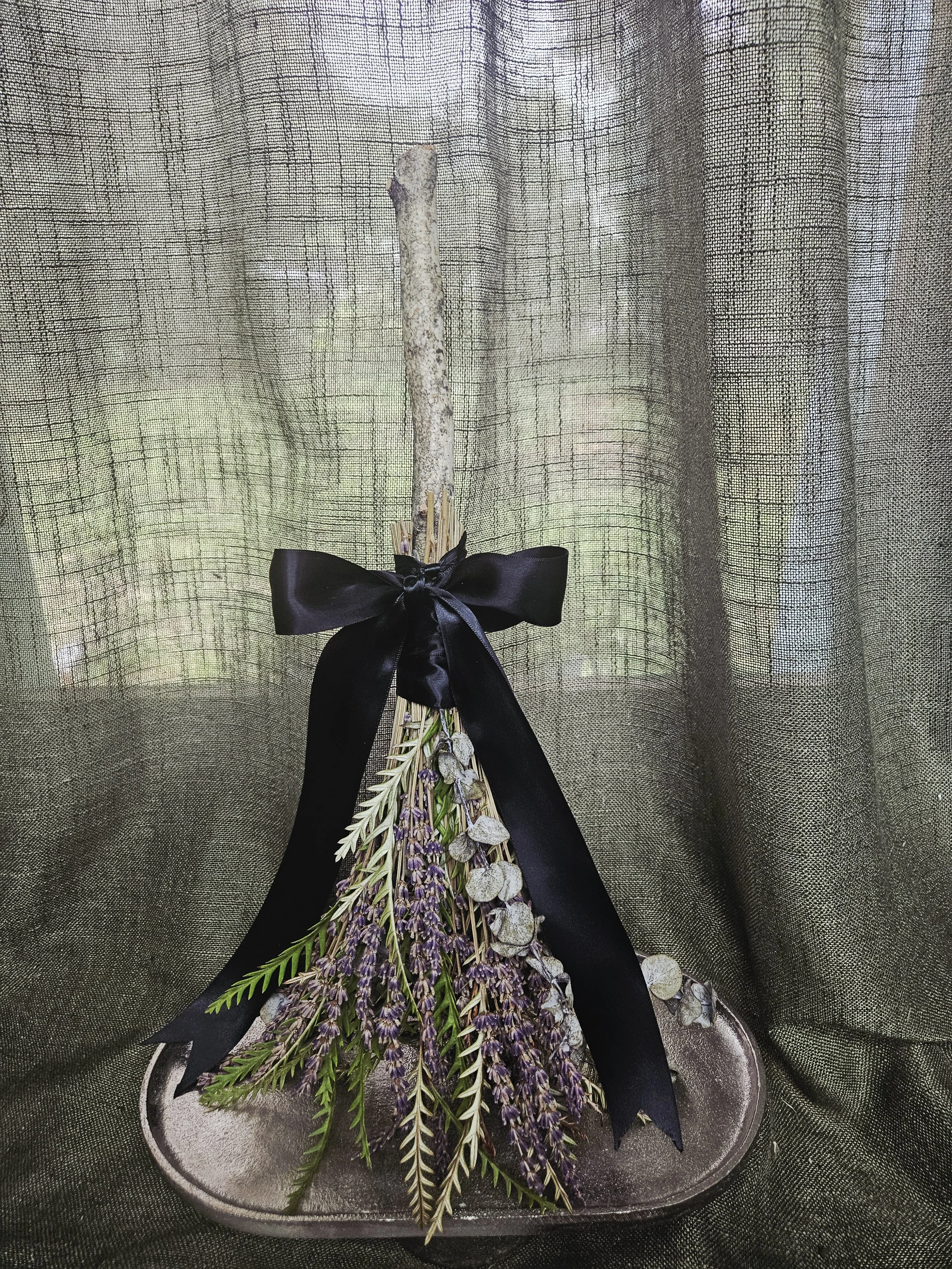 Handmade witch broom with dried flowers and herbs