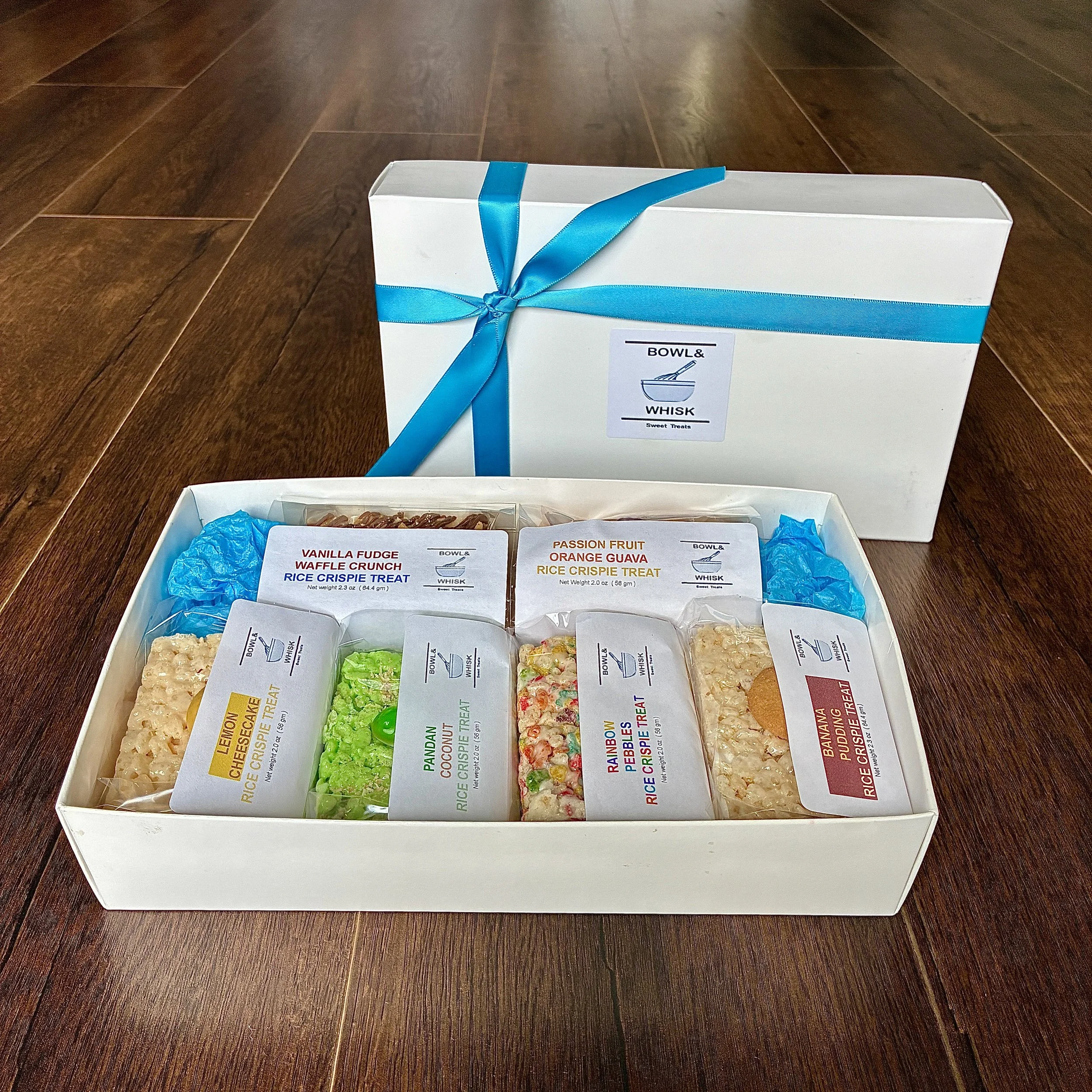 Our Sept 2026 Gift Box of Individually Wrapped Rice Crispie Treats, containing 1 piece each of banana pudding, guava matcha, rainbow pebbles, root beer float, strawberry margarita and strawberry shortcake flavors.