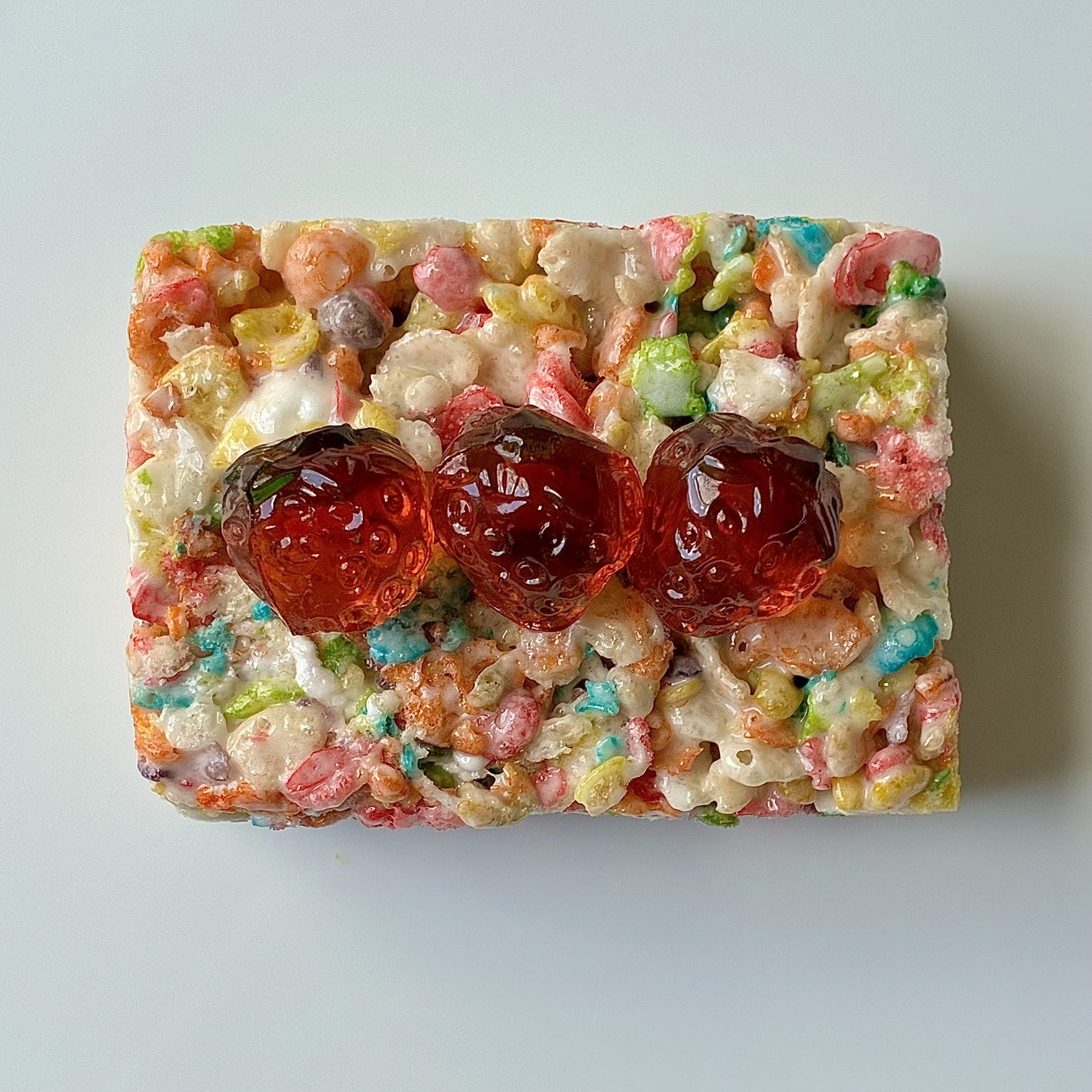 STRAWBERRY TOPPED RAINBOW PEBBLES RICE CRISPIE TREATS