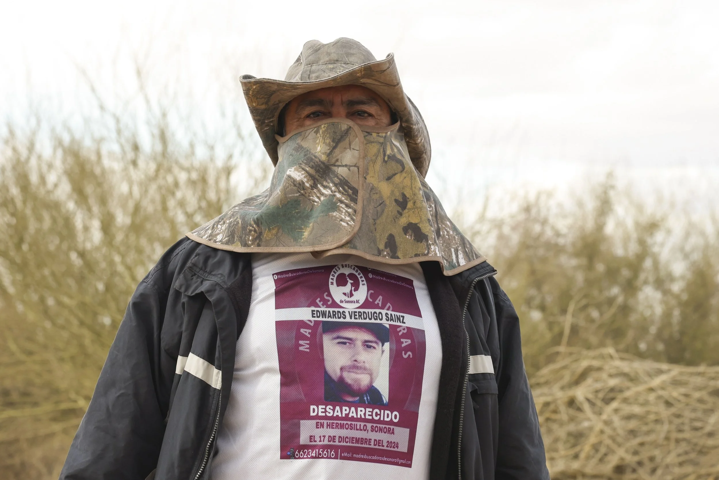 Cristóbal wears his missing son's portrait on his sweater.
Name and date below the photo.