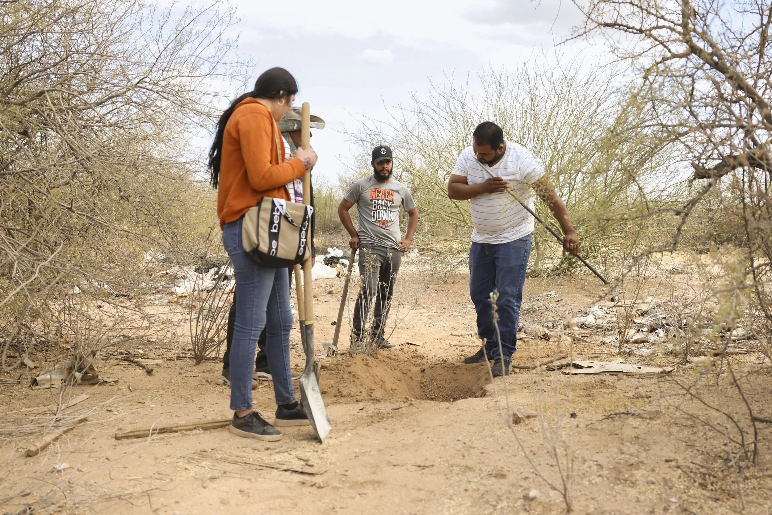 He pulls the rod from the ground.
Smells it for signs of decomposition.
