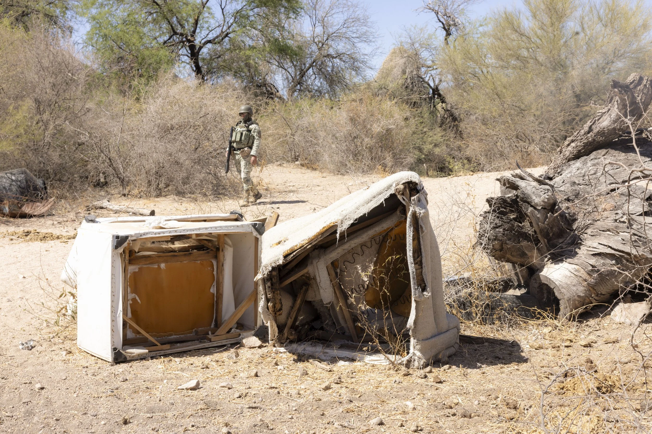 Searching an area used as a dump.
Military and garbage, side by side.