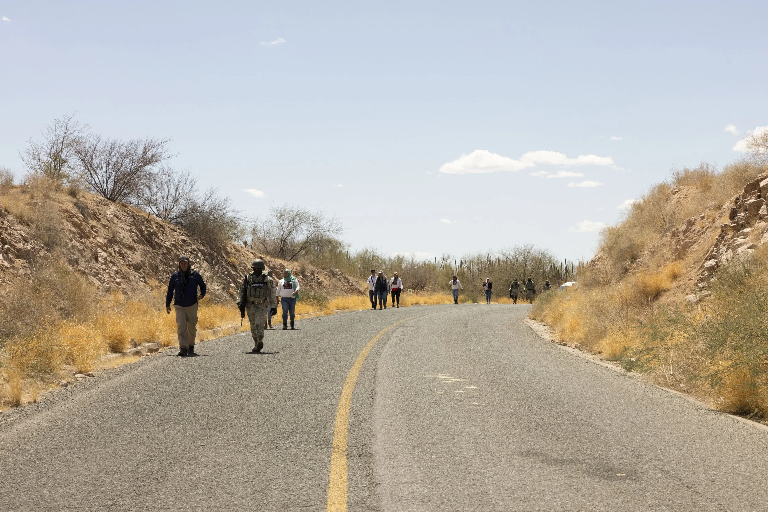 The search continues along the road.
Madres Buscadoras, military, and police.
