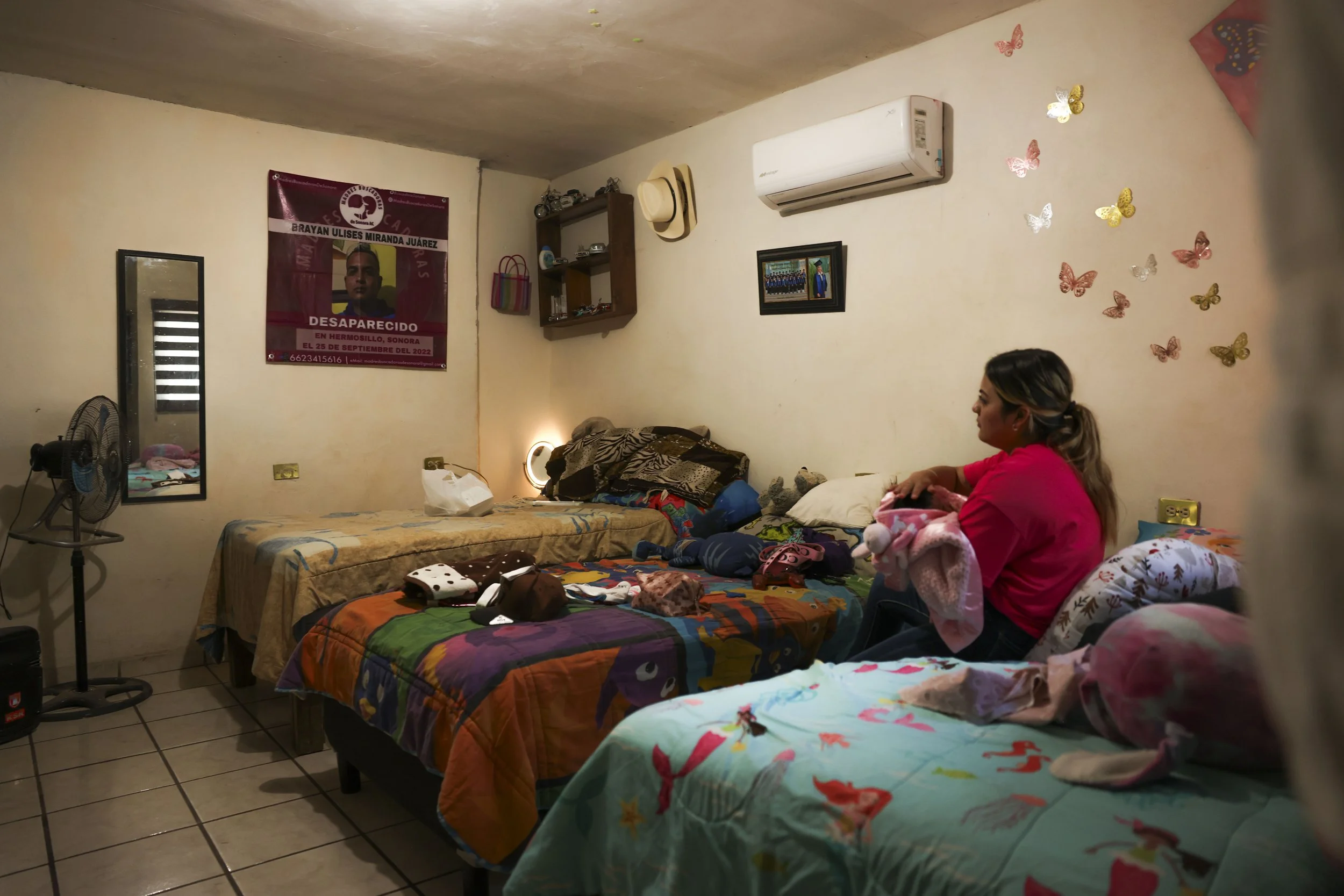 Jennifer looks at a photo of her missing brother.
His name is Brayan.