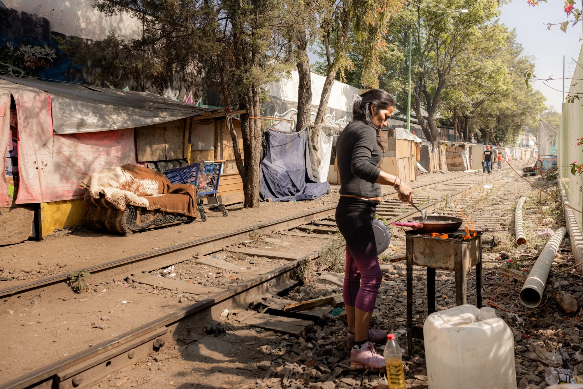 Breakfast being prepared by the railway tracks.