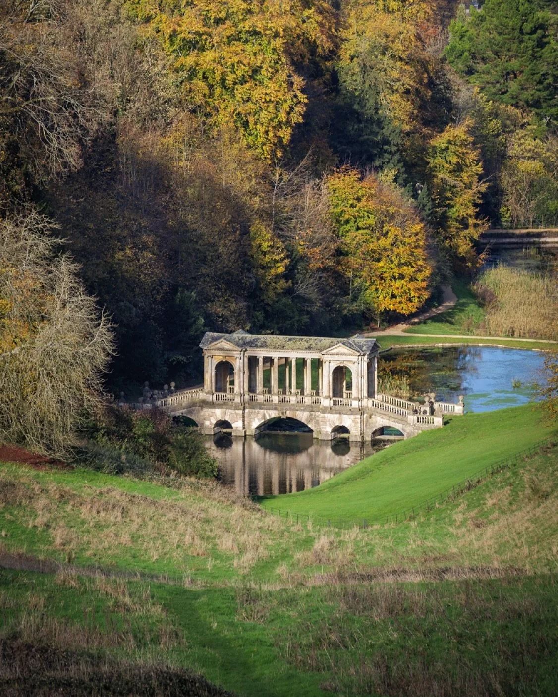 Bath has this brilliant secret: you can wander into corners of the city that feel miles from anything urban. Prior Park is exactly that. I always find myself heading back there in autumn. The Palladian Bridge sits in the valley like a little architec