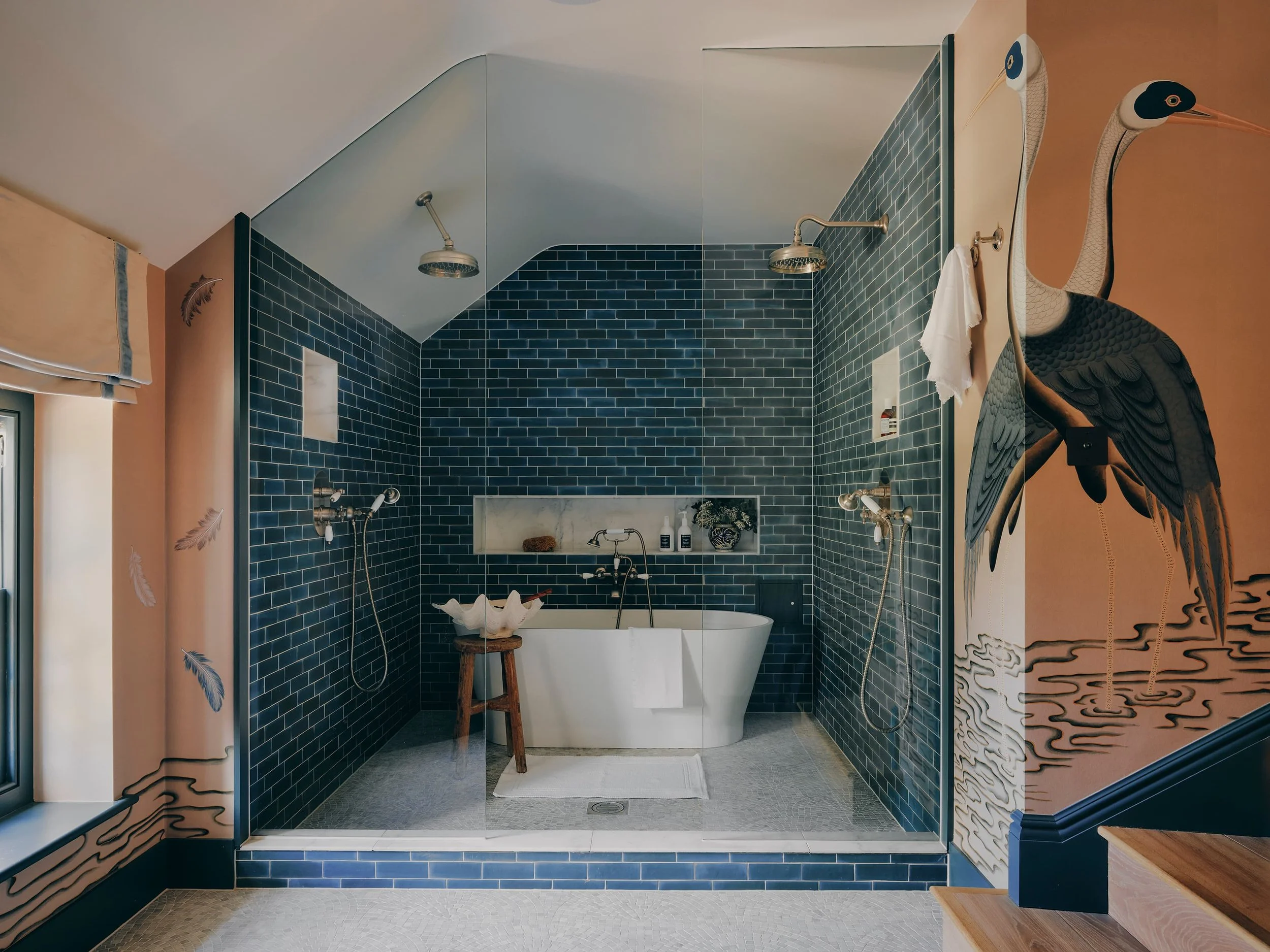 "Bathroom with freestanding bath and tiled walk-in shower in a Jersey rural rectory by Bryony Richardson"