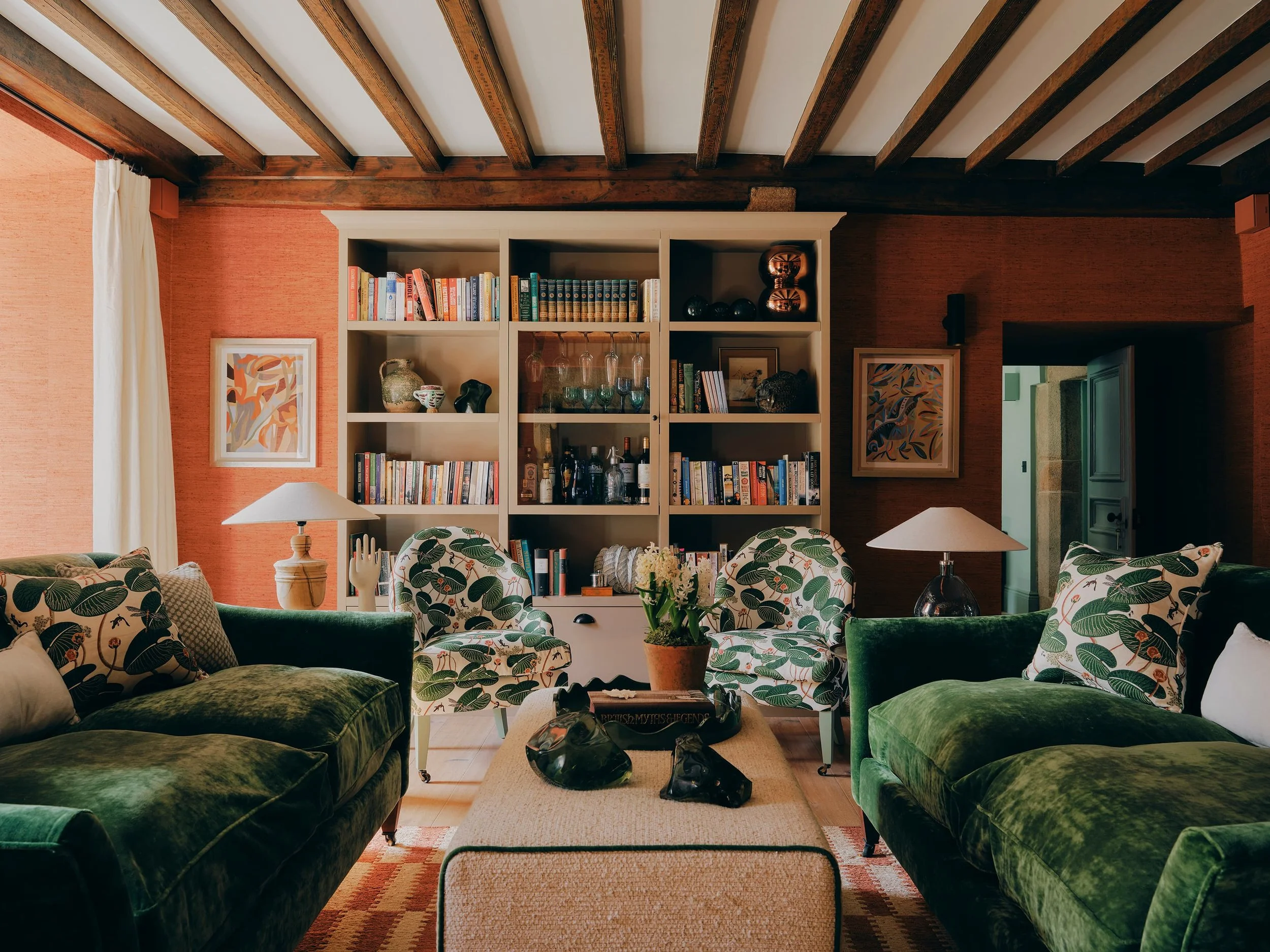 "Library with reclaimed wooden bookcase,and wooden desk and whicker chair in a Jersey rural rectory by Bryony Richardson"