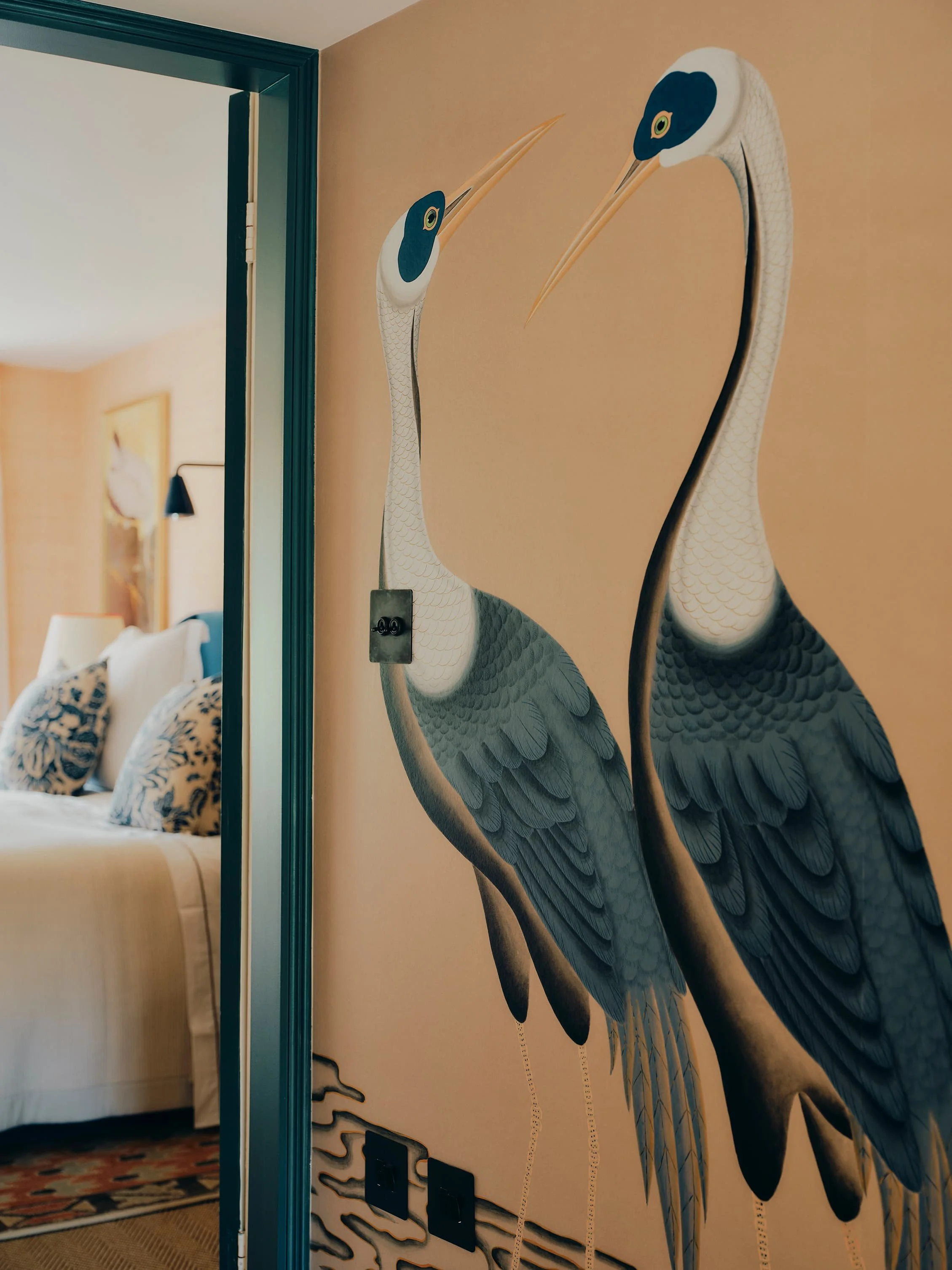 "Hand-painted heron wallpaper outside a bedroom in a Jersey rural rectory by Bryony Richardson"
